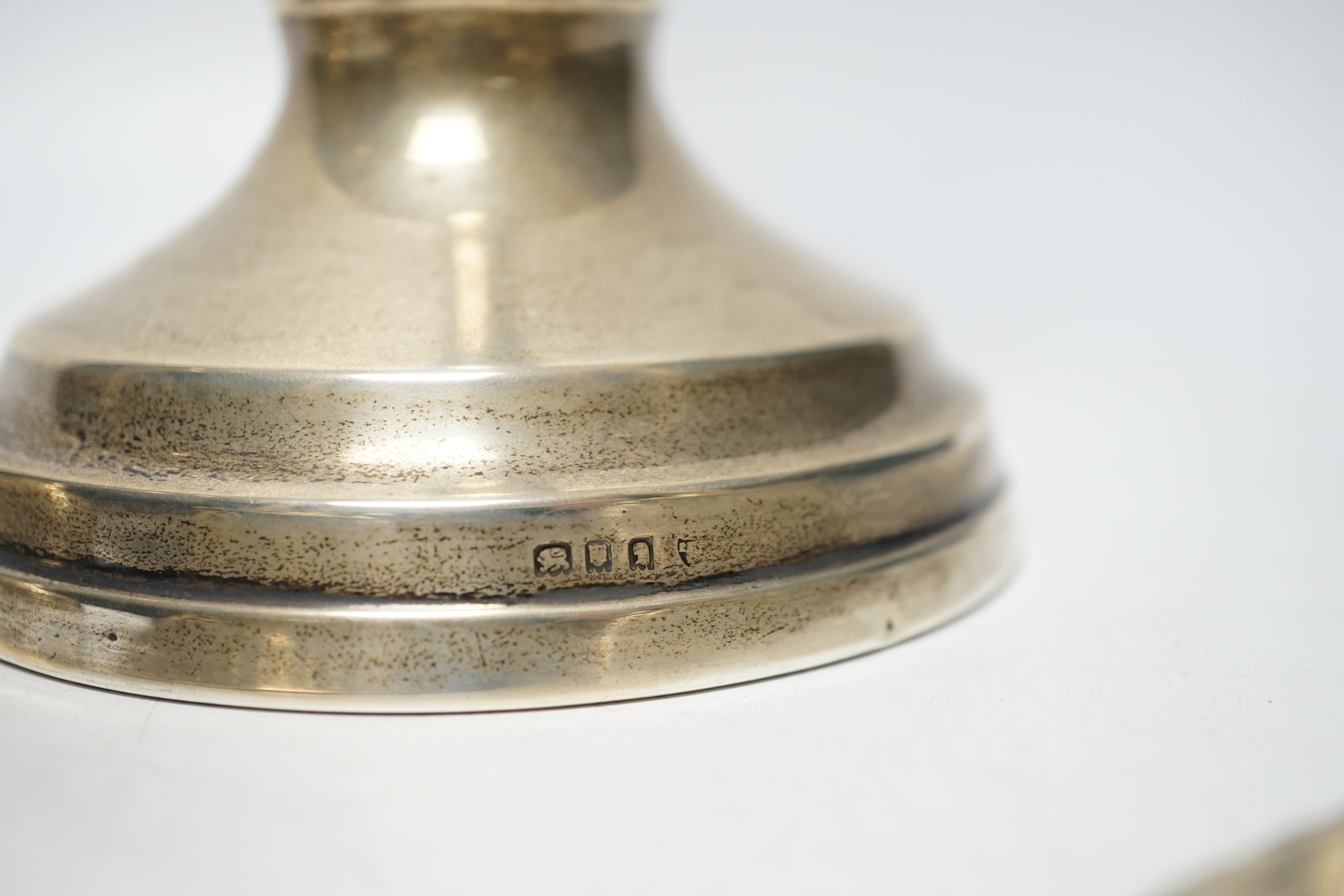 A pair of Victorian silver candlesticks, on pierced swept bases, William Leuchars, London, 1886, 15.2cm, weighted and a later taller pair of silver candlesticks.